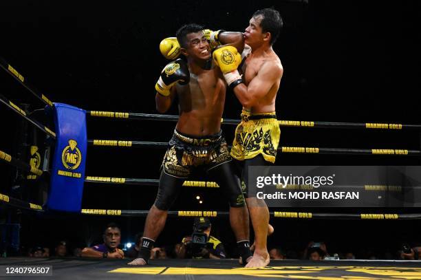 This photo taken on May 20, 2022 shows Muay Thai boxers competing during a competition in Kota Bharu, Malaysia's Kelantan state.
