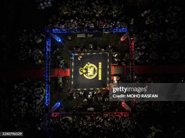 This aerial photo taken on May 20, 2022 shows Muay Thai boxers competing in the ring during a competition in Kota Bharu, Malaysia's Kelantan state.
