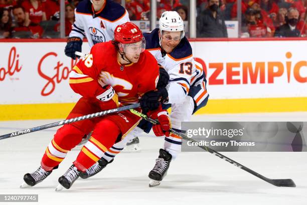 Andrew Mangiapane of the Calgary Flames skates against Jesse Puljujarvi of the Edmonton Oilers in Game Two of the Second Round of the 2022 Stanley...