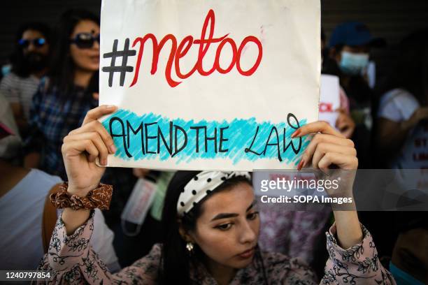Youth holds a placard expressing her opinion during the demonstration near the prime minister's residence in Kathmandu. Hundreds of youth gathered...
