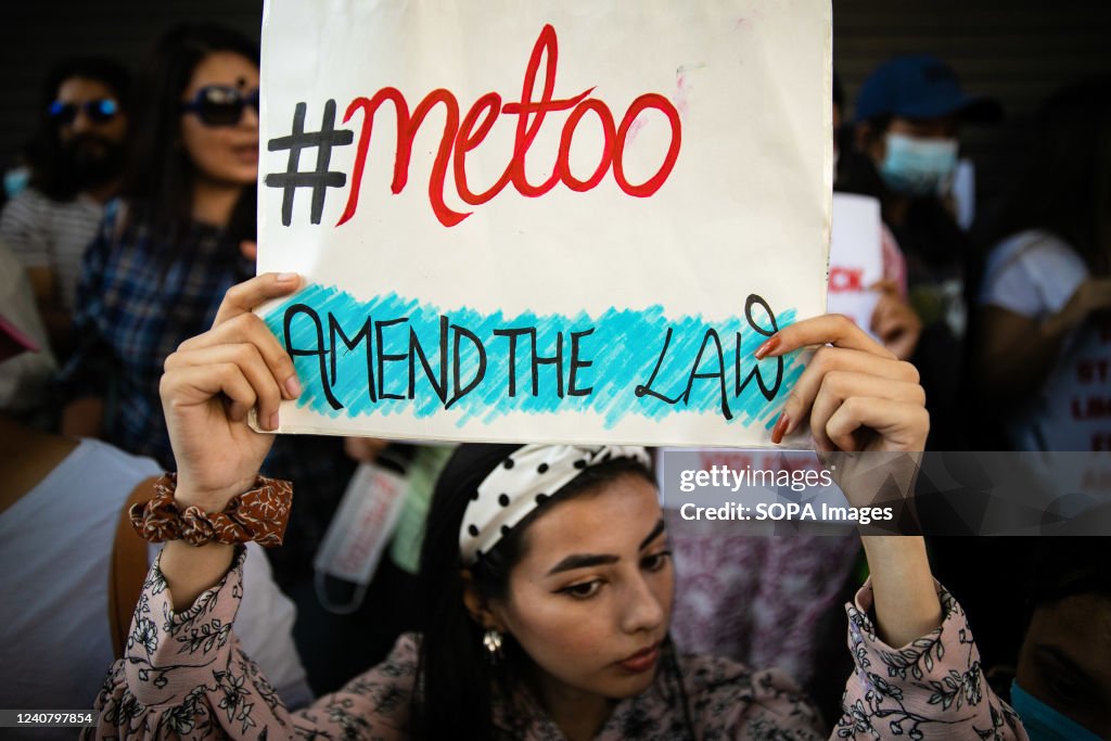 A youth holds a placard expressing her opinion during the...