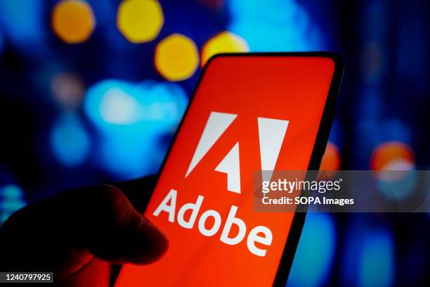 In this photo illustration, the Adobe Inc. Logo seen displayed on a smartphone screen.