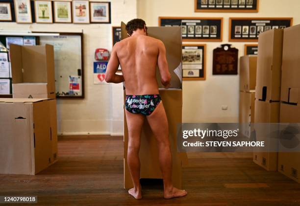 Man casts his vote during Australia's general election at a polling station at Bondi Beach in Sydney on May 21, 2022.