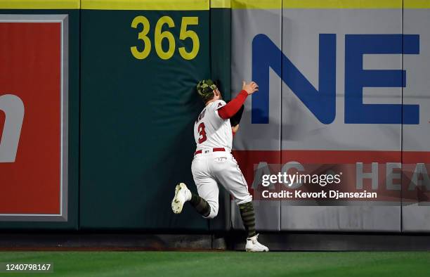 Taylor Ward of the Los Angeles Angels collides with the right field wall after making a catch on a fly ball hit by Tony Kemp of the Oakland Athletics...