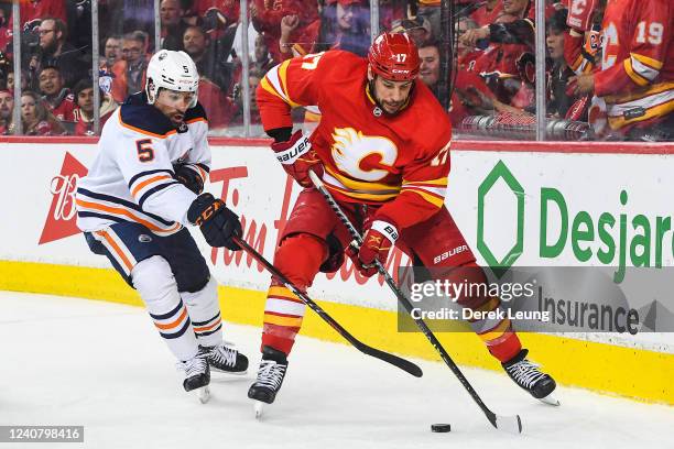 Milan Lucic of the Calgary Flames carries the puck against Cody Ceci of the Edmonton Oilers during the third period of Game Two of the Second Round...