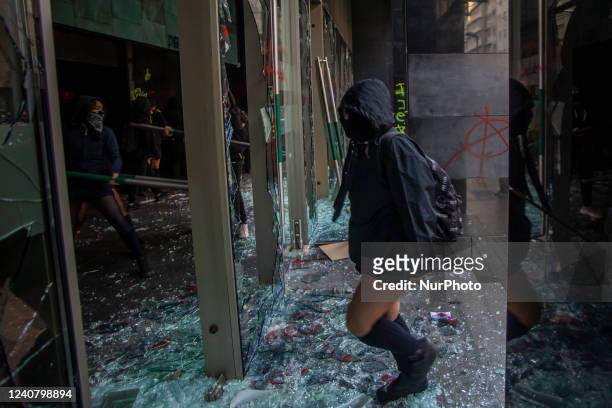 Students destroy the entrance to the JUNAEB office during a protest of students from public education, outside the JUNAEB office demanding decent...