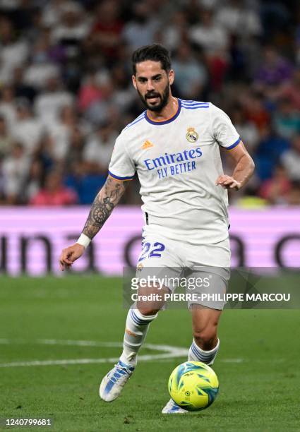 Real Madrid's Spanish midfielder Isco dribbles the ball during the Spanish league football match between Real Madrid CF and Real Betis at the...