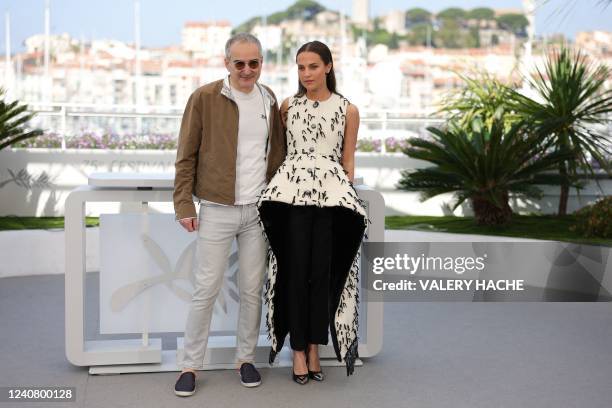 French director Olivier Assayas and Swedish actress Alicia Vikander pose during a photocall for the film "Irma Vep" at the 75th edition of the Cannes...