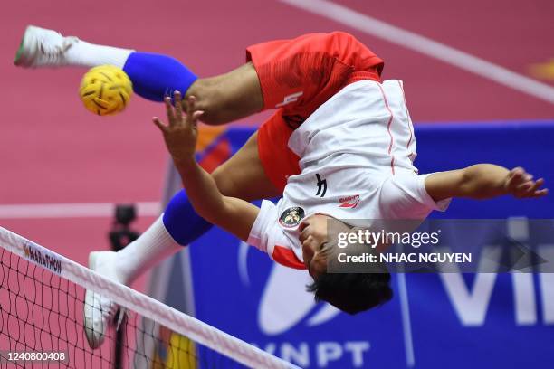 Indonesia's Rusdi kicks the ball in the men's sepak takraw final between Indonesia and Thailand during the 31st Southeast Asian Games in Hanoi on May...