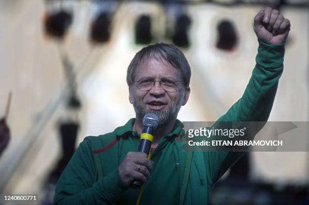 Colombian presidential candidate for the Green Party, Antanas Mockus, raises his fist as he delivers a speech during a rally in Bogota on May 16,...