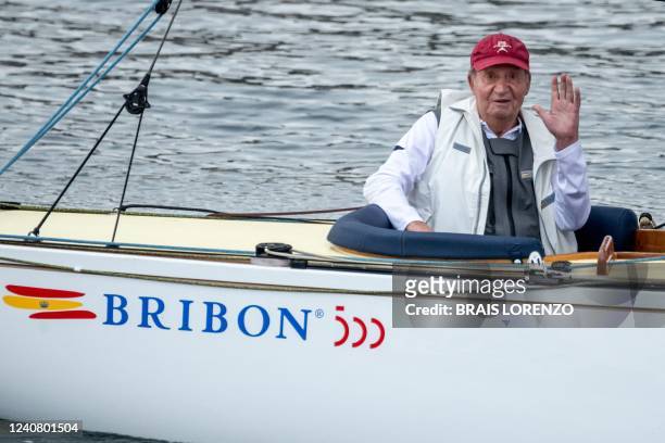 Spain's former King Juan Carlos I waves from his "Bribon" boat, as he attends the regatta of the InterRias trophy of 6M Spanish Cup, in the Galician...