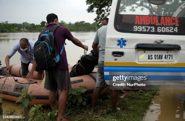 Jawan loading the dead body of Binanda Nath , on an ambulance, who was dead in flood water after flooding flowing heavy rainfall, in Nagaon, Assam,...