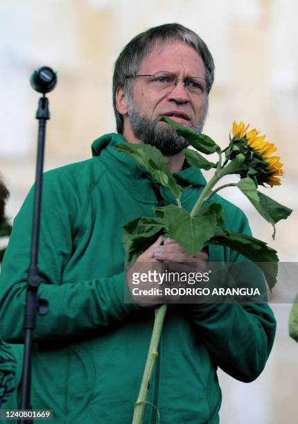 Colombian presidential candidate for the Partido Verde , Antanas Mockus holds a flower during his closing campaign rally in Bogota on May 23, 2010....