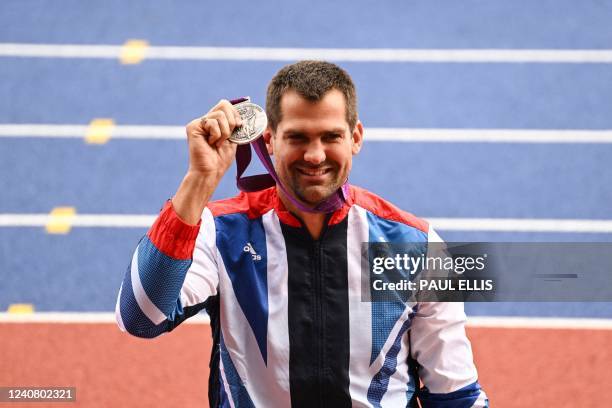 Britain's Robbie Grabarz celebrates on the podium as he receives his London 2012 Olympic silver medal for the high jump competition, during the IAAF...