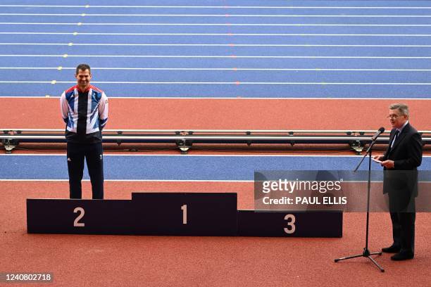 Britain's Robbie Grabarz celebrates on the podium as he receives his London 2012 Olympic silver medal for the high jump competition, during the IAAF...