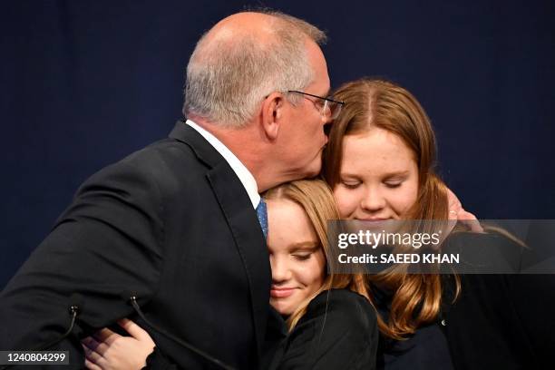 Australia's Prime Minister Scott Morrison gives a hug to his daughters Lily and Abbey following the results of the federal election during the...