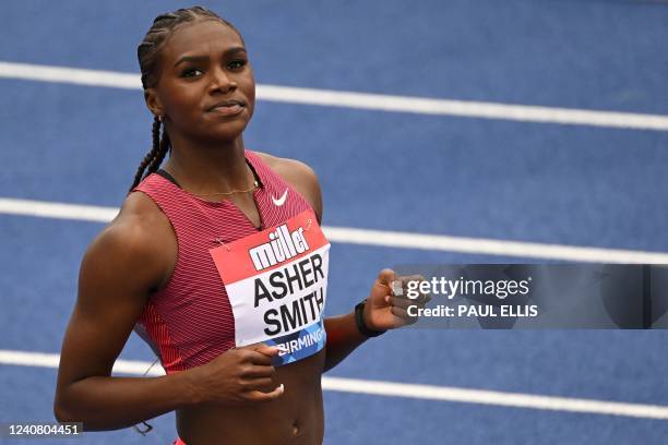 Britain's Dina Asher-Smith celebrates after winning the Women's 100m during the IAAF Diamond League athletics Birmingham meeting at the Alexander...