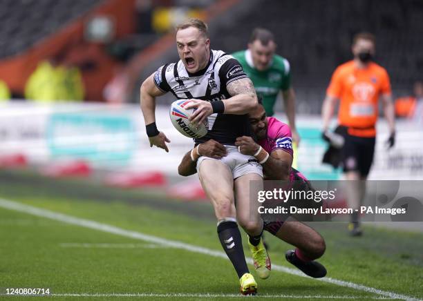 Hull FC's Adam Swift and Wigan Warriors' Bevan French battle for the ball during the Betfred Super League match at the MKM Stadium, Kingston upon...