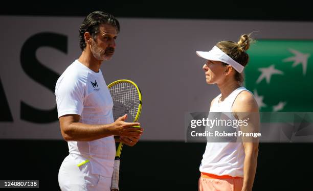 Simona Halep of Romania talks to coach Patrick Mouratoglou of France during practice at Roland Garros on May 21, 2022 in Paris, France