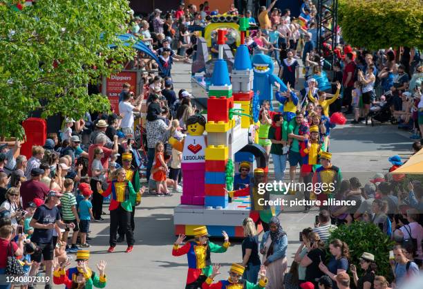 May 2022, Bavaria, Günzburg: A colorful parade moves through the theme park Legoland. The German Legoland opened in May 2002 and celebrates this with...