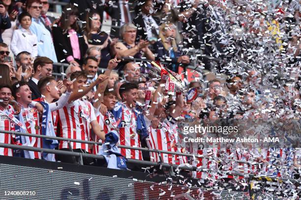 Sunderland celebrate winning promotion as Corry Evans of Sunderland lifts the trophy with his team mates during the Sky Bet League One Play-Off Final...