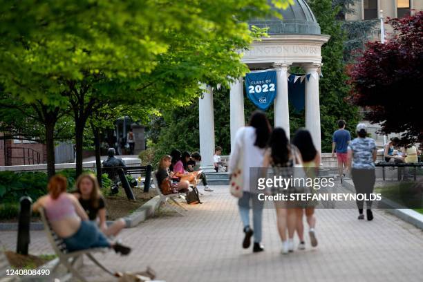 Class of 2022 banner is displayed as students walk on campus at George Washington University in Washington, DC, on May 2, 2022.