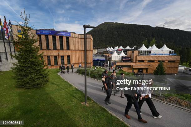 Staff is walking outside the congress centre ahead of the World Economic Forum annual meeting in Davos on May 21, 2022. - The world's political and...