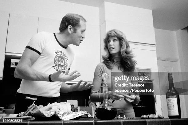 Husband and wife actors Jill Townsend and Nicol Williamson cooking together at home in London, circa December 1975.