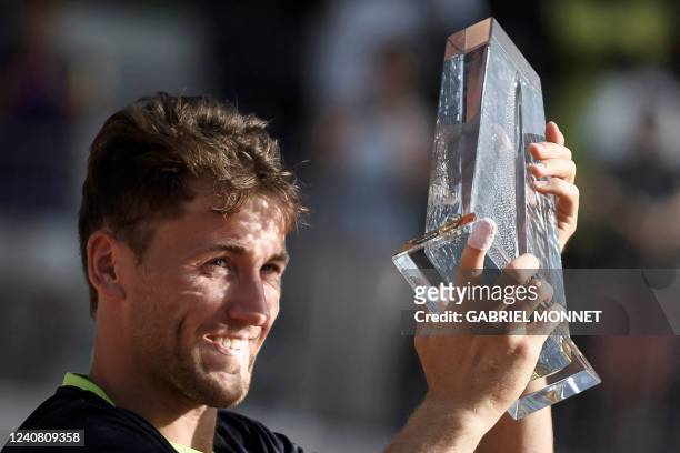 Norways Casper Ruud raises the trophy after beating Portugals Joao Sousa during their men's single final match at the ATP 250 Geneva Open tennis...
