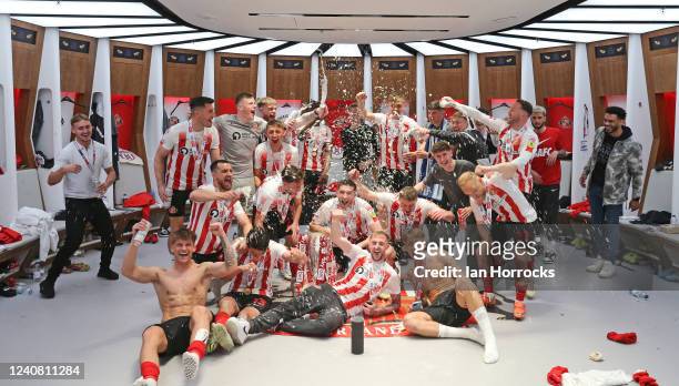 Sunderland players and staff celebrate in the dressing room following the Sky Bet League One Play-Off Final match between Sunderland and Wycombe...