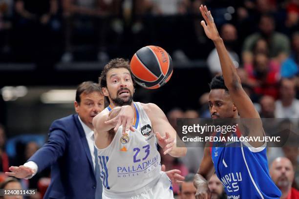 Real Madrid's Sergio Llull shoots the ball past Anadolu Efes' Rodrigue Beaubois during the EuroLeague Final Four final basketball match between Real...