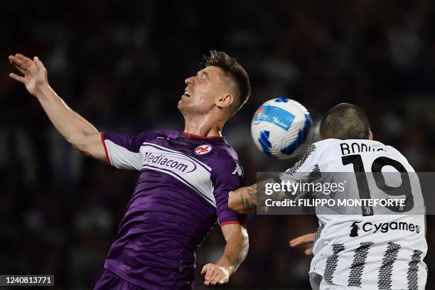 Fiorentina's Polish forward Krzysztof Piatek and Juventus' Italian defender Leonardo Bonucci go for a header during the Italian Serie A football...