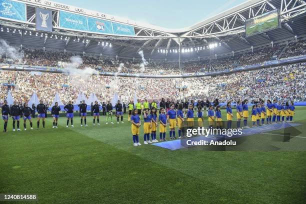 Barcelona and Olympique Lyonnais players line up before the start of their Women Champions League football match at Juventus Stadium in Turin, Italy,...