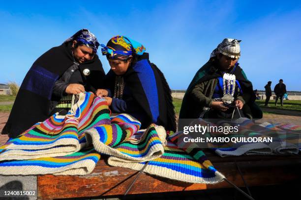 Indigenous Mapuche women weave on a loom a 1-kilomemter weave in an attempt to break a Guinness Record in Puerto Saavedra, Chile on May 21,2022. -...