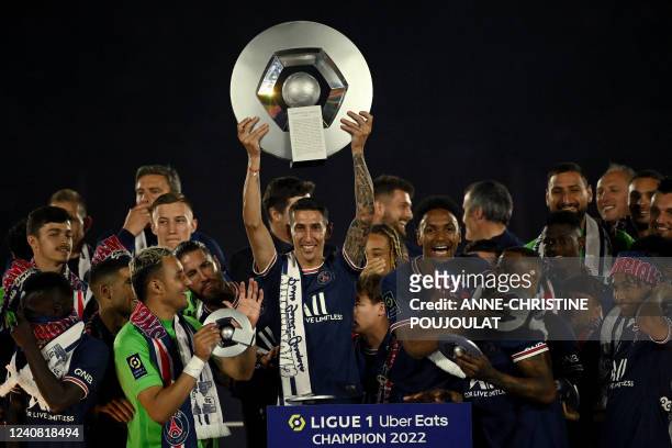Paris Saint-Germain's Argentinian midfielder Angel Di Maria holds the trophy as he celebrates with team mates their club's tenth Ligue 1 title during...