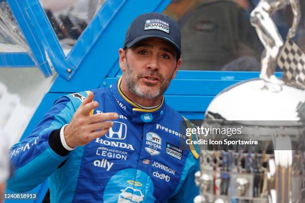 DdINDIANAPOLIS, IN NTT IndyCar series driver Jimmie Johnson stands near the Borg Warner Trophy on May 21st, 2022 after qualifying for the 106th...