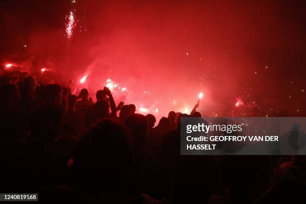Fans celebrate outside the stadium after the French L1 football match between Paris-Saint Germain and FC Metz at The Parc des Princes Stadium in...