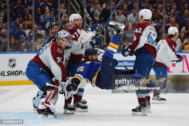 Darcy Kuemper and J.T. Compher of the Colorado Avalanche defend the goal against Jordan Kyrou of the St. Louis Blues in the first period of Game...