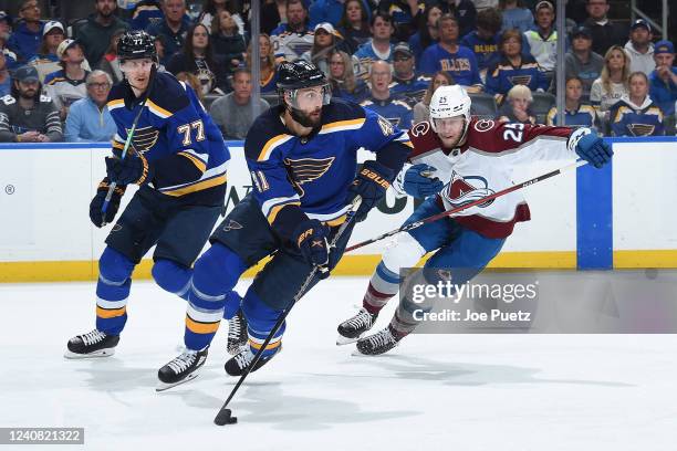 May 21: Logan O'Connor of the Colorado Avalanche pressures Robert Bortuzzo of the St. Louis Blues in Game Three of the Second Round of the 2022...