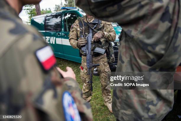 Soldier carrying a machine gun is seen at the military picnic. Recruitment for Polands new voluntary general military service begins from May 21st as...