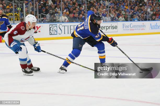 Robert Bortuzzo of the St. Louis Blues controls the puck against Erik Johnson of the Colorado Avalanche in the third period during Game Three of the...