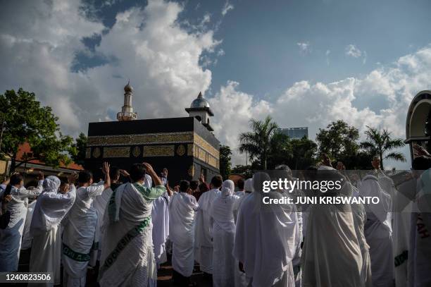 Indonesian Muslims simulate the circumambulation of a mock kaaba as part of preparations ahead of their Hajj pilgrimage, one of the five pillars of...