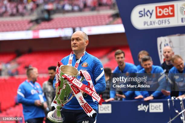 Alex Neil manager of Sunderland celebrates promotion to the Championship with the trophy during the Sky Bet League One Play-Off Final match between...