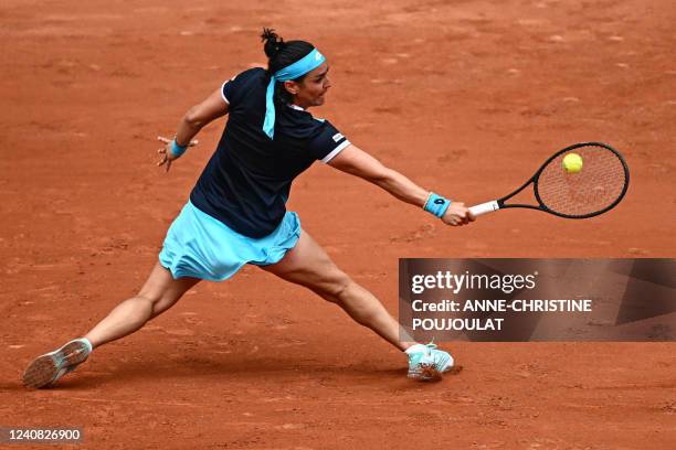 Tunisia's Ons Jabeur plays a forehand return to Poland's Magda Linette during their women's singles match on day one of the Roland-Garros Open tennis...