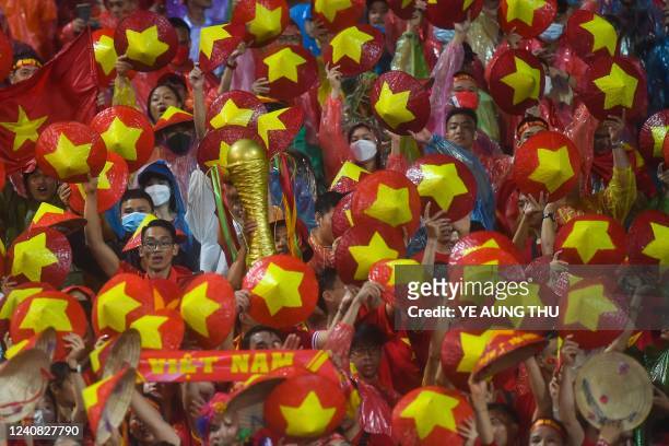 Vietnam's supporters cheer the team on in the men's football final match against Thailand during the 31st Southeast Asian Games in Hanoi on May 22,...