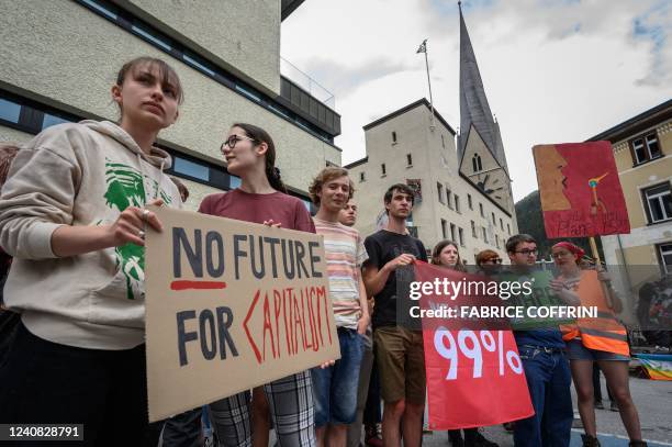 Young protesters take part in a demonstration against the World Economic Forum during the WEF annual meeting in Davos on May 22, 2022.