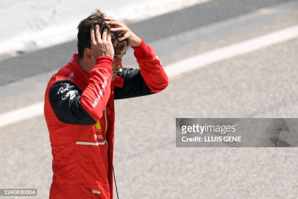 Ferrari's Monegasque driver Charles Leclerc reacts at the pitlane after his car's breakdown during the Spanish Formula One Grand Prix at the Circuit...