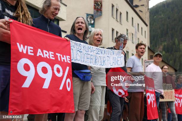 Protesters against the World Economic Forum hold a placards ahead of the forum in Davos, Switzerland, on Sunday, May 22, 2022. The annual Davos...