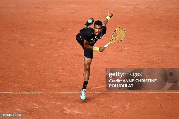 Canada's Felix Auger-Aliassime serves to Peru's Juan Pablo Varillas during their men's singles match on day one of the Roland-Garros Open tennis...