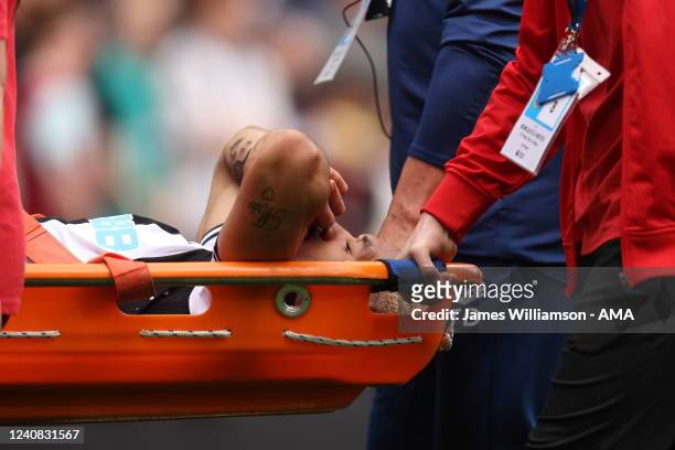 Joelinton of Newcastle United is stretchered off during the Premier League match between Burnley and Newcastle United at Turf Moor on May 22, 2022 in...